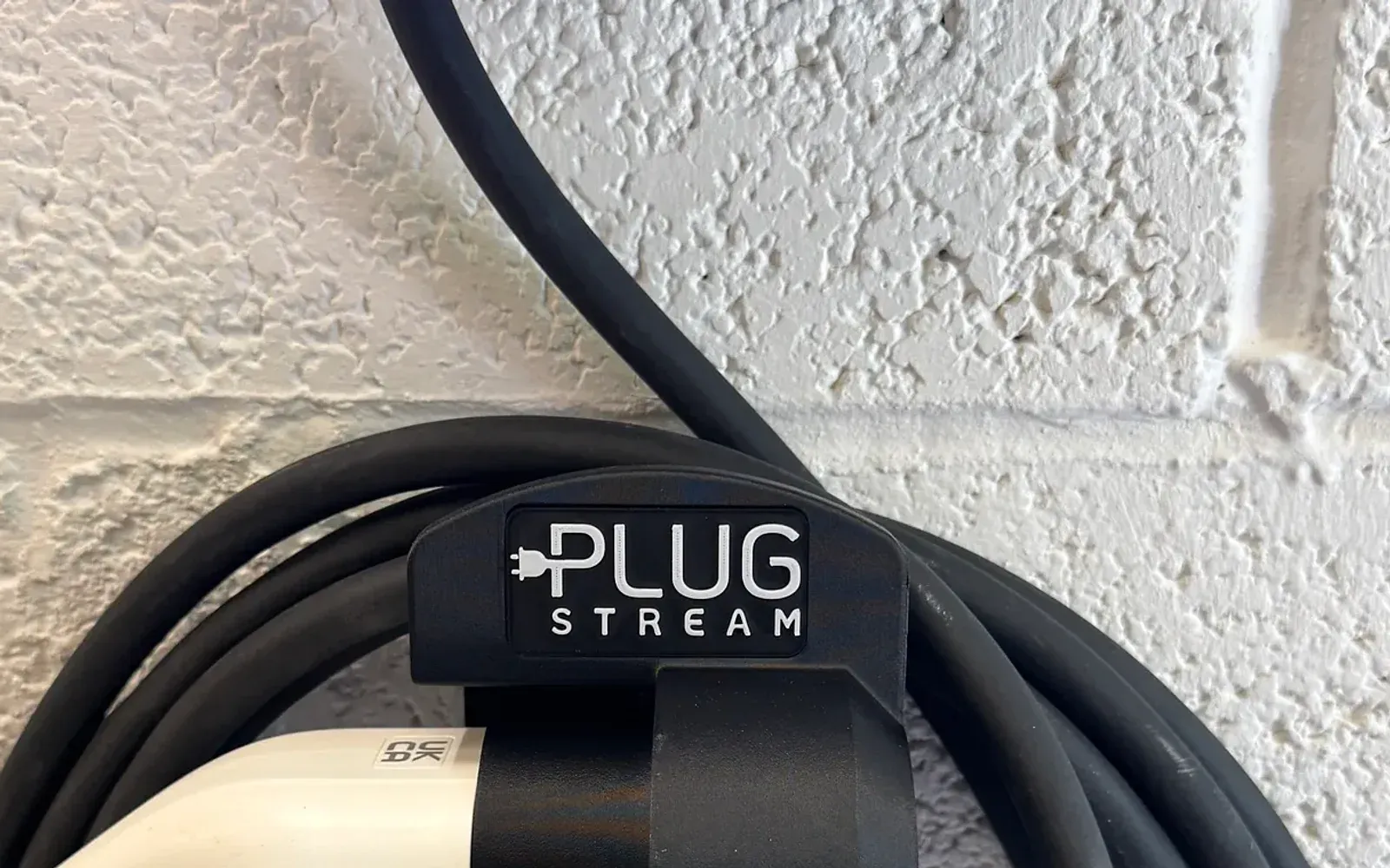 PlugStream Dock holding an EV charging connector and cable loop