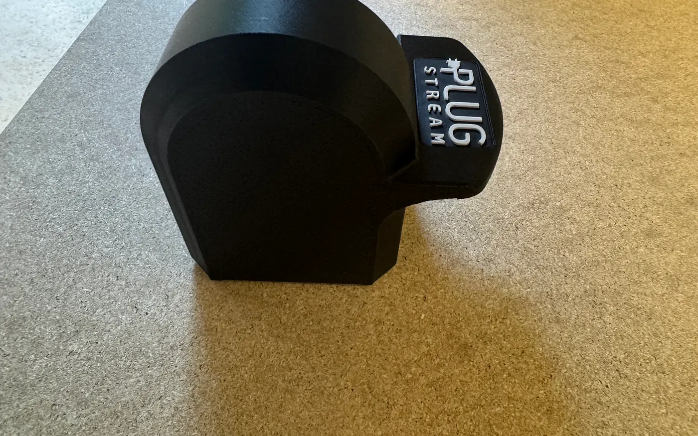 Side view of PlugStream Dock showing the compact holder shape
