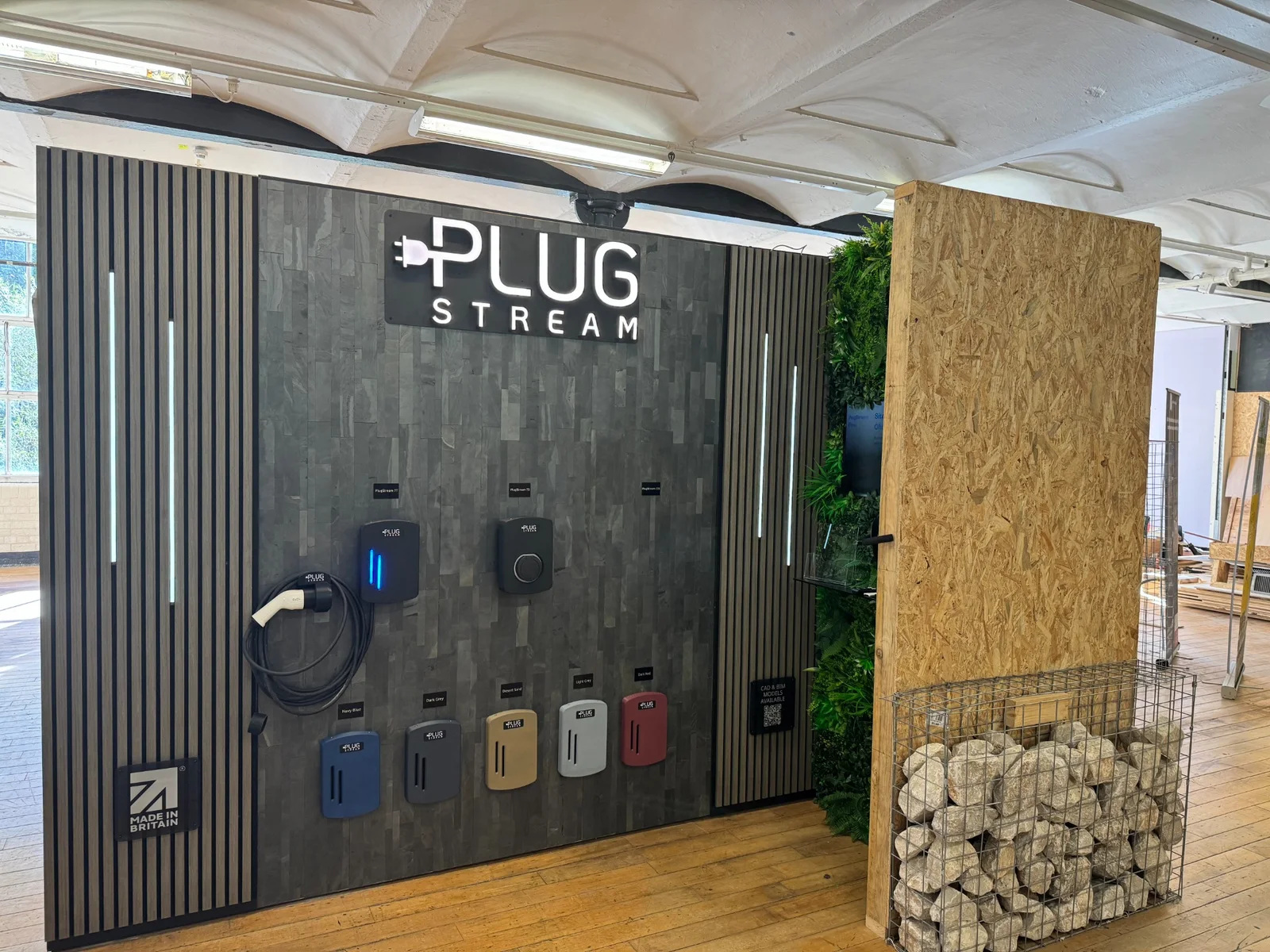 Illuminated PlugStream exhibition stand at Masson Mills with chargers and colour samples